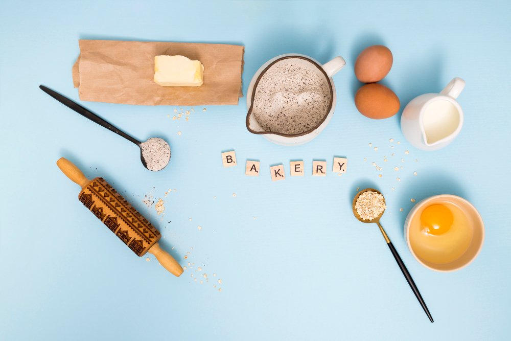 overhead-view-bakery-blocks-with-bread-ingredients-blue-background